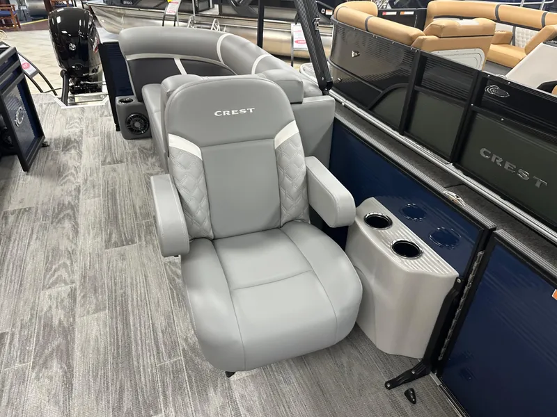 Slide: The Image of 2025 Crest Classic 220 boat interior with gray seating and cup holders. - 9