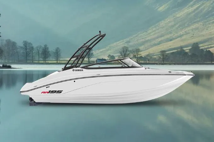 Slide: The Image of 2025 Yamaha Boats AR195 on serene lake with scenic mountain backdrop. - 0