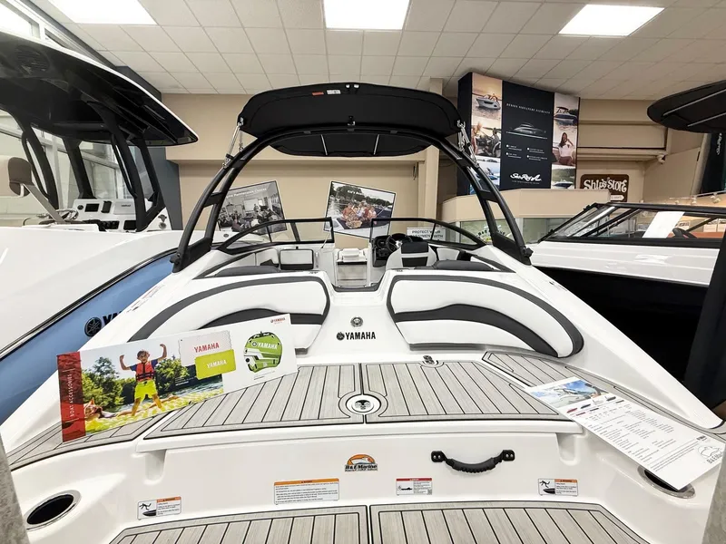 Slide: The Image of 2025 Yamaha Boats AR195 displayed in showroom with promotional materials. - 1