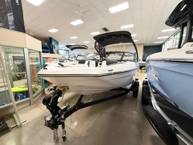 Slide: The Image of 2025 Yamaha Boats AR195 displayed in a showroom, featuring sleek design and modern amenities. - 2