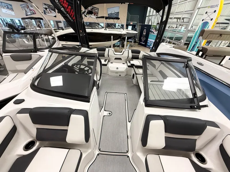 Slide: The Image of 2025 Yamaha Boats AR195 interior with sleek seating and modern design in showroom. - 8