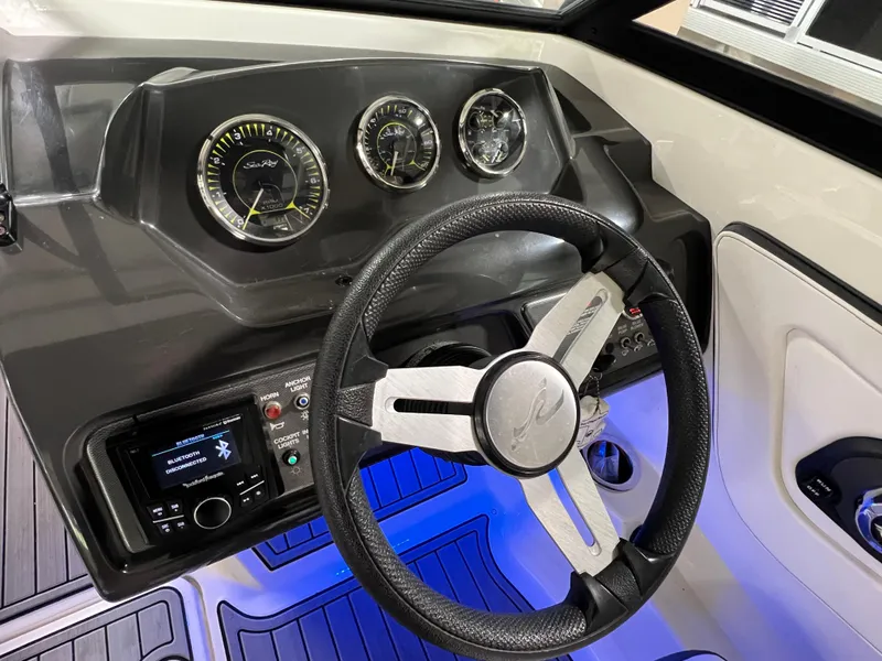Slide: The Image of 2017 Sea Ray SPX 190 dashboard with steering wheel and illuminated controls. - 10