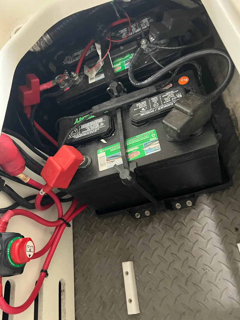 Slide: The Image of 2017 Sea Ray SPX 190 boat battery compartment with wiring and connections. - 13