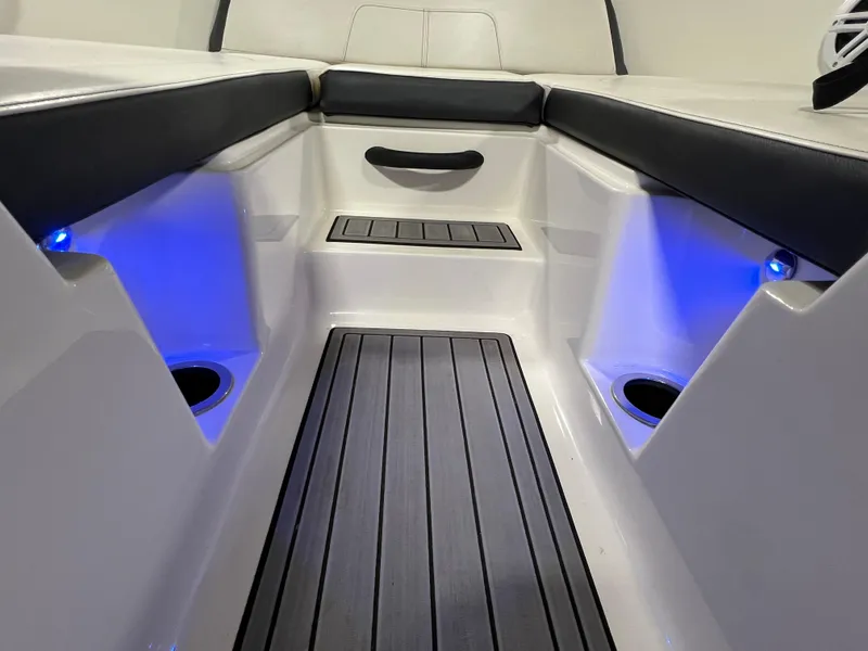 Slide: The Image of 2017 Sea Ray SPX 190 boat interior with blue LED lighting and sleek seating. - 7