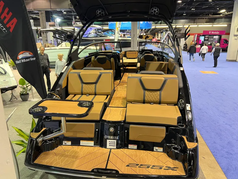 Slide: The Image of 2025 Yamaha Boats 255XD interior at a boat show, featuring luxurious seating and modern design. - 3