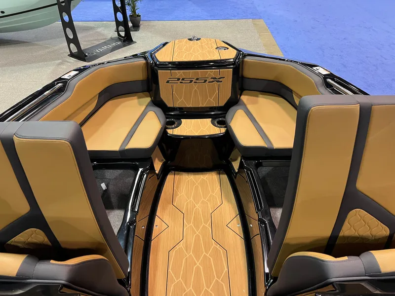 Slide: The Image of 2025 Yamaha Boats 255XD interior with luxurious tan and black seating. - 7