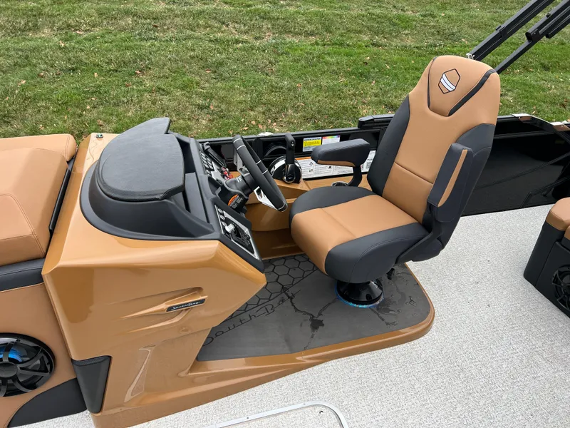 Slide: The Image of 2025 South Bay 523 ULE 3.0+ boat interior with tan and black captain's chair. - 10