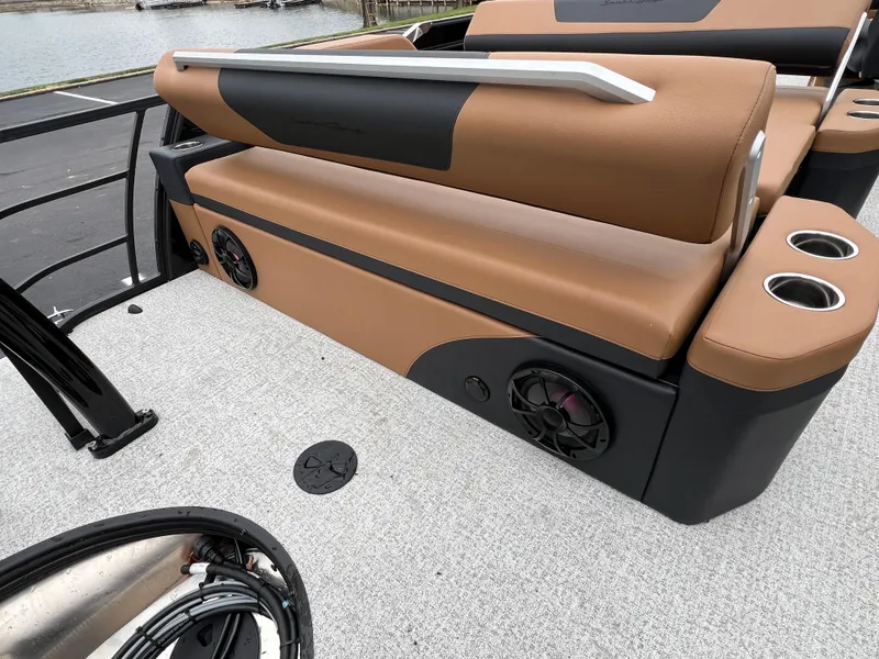 Slide: The Image of 2025 South Bay 523 ULE 3.0+ boat interior with brown seating and cup holders. - 18