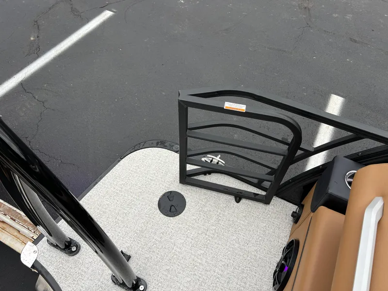 Slide: The Image of 2025 South Bay 523 ULE 3.0+ boat deck with open gate, black railing, and parking lot. - 20