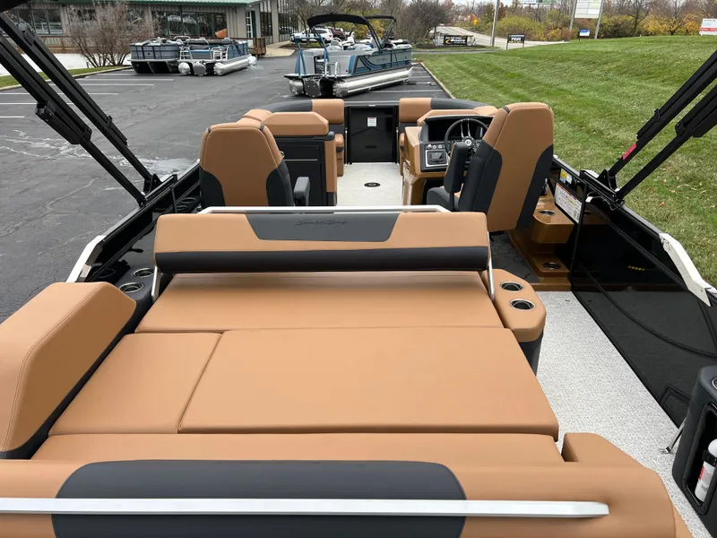 Slide: The Image of 2025 South Bay 523 ULE 3.0+ pontoon boat interior with tan seating and modern design. - 21