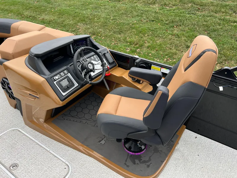 Slide: The Image of 2025 South Bay 523 ULE 3.0+ boat interior with tan and black captain's chair. - 23