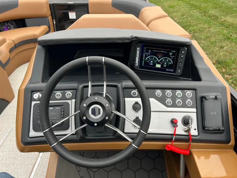 Slide: The Image of Steering console of 2025 South Bay 523 ULE 3.0+ pontoon boat with modern controls. - 25