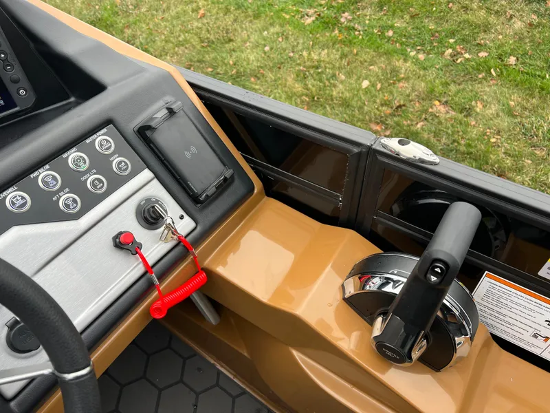 Slide: The Image of Control panel of 2025 South Bay 523 ULE 3.0+ boat with throttle and switches. - 27