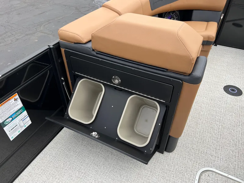 Slide: The Image of 2025 South Bay 523 ULE 3.0+ boat interior with storage compartments and tan seating. - 29