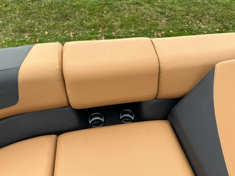 Slide: The Image of 2025 South Bay 523 ULE 3.0+ boat seating with tan and gray upholstery. - 32