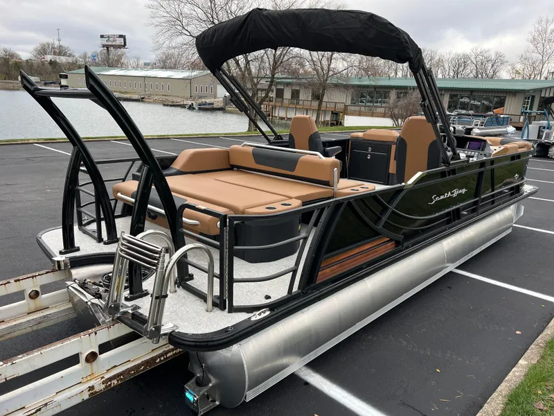 Slide: The Image of 2025 South Bay 523 ULE 3.0+ pontoon boat with tan seating and black canopy. - 4