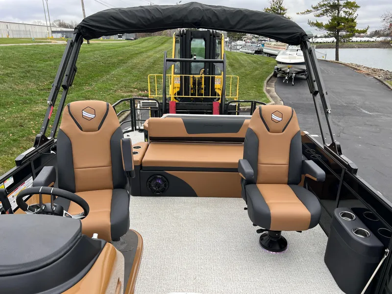 Slide: The Image of 2025 South Bay 523 ULE 3.0+ pontoon boat interior with tan and black seating. - 9