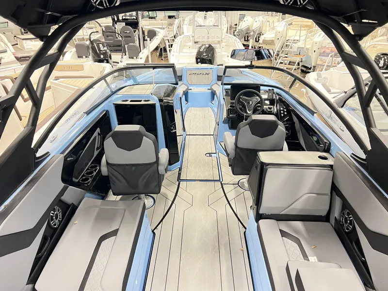 Slide: The Image of 2025 Yamaha Boats 255XD interior, showcasing modern seating and sleek design in a showroom setting. - 8