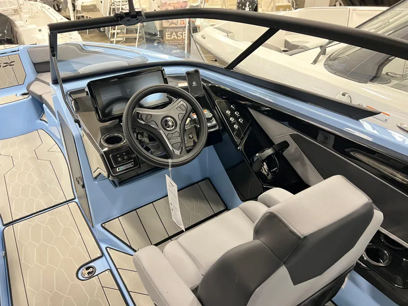 Slide: The Image of 2025 Yamaha Boats 255XD cockpit with modern steering and dashboard controls. - 9