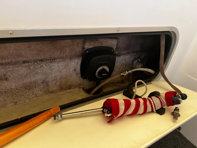 Slide: The Image of 1995 Bayliner 2859 Classic Cruiser interior compartment with tools and equipment. - 12