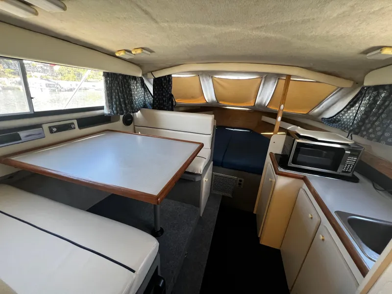 Slide: The Image of Interior of 1995 Bayliner 2859 Classic Cruiser with dining area and kitchenette. - 13