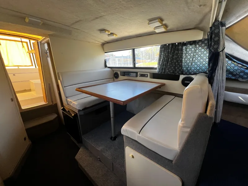 Slide: The Image of Interior of 1995 Bayliner 2859 Classic Cruiser with dining area and seating. - 14