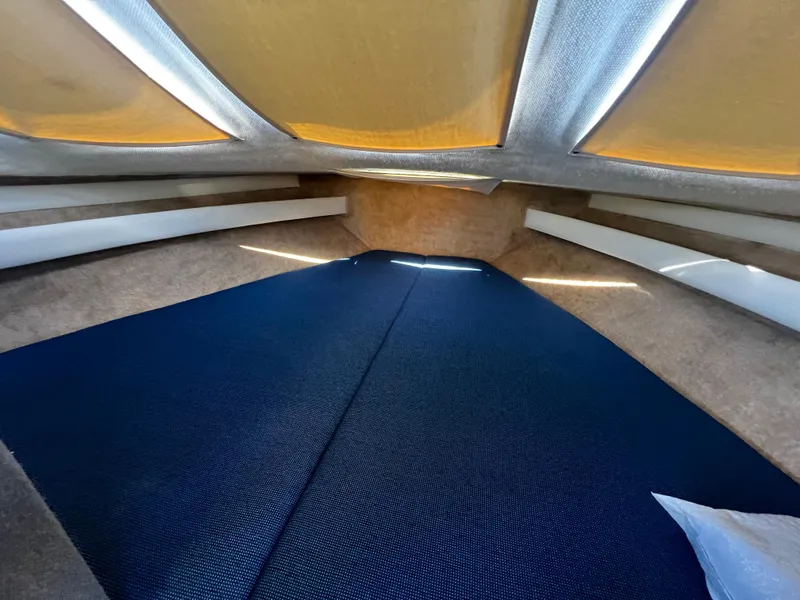 Slide: The Image of Interior cabin of 1995 Bayliner 2859 Classic Cruiser with blue bedding. - 15