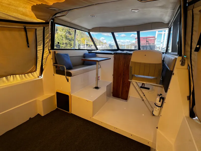 Slide: The Image of Interior of 1995 Bayliner 2859 Classic Cruiser with seating and helm. - 6