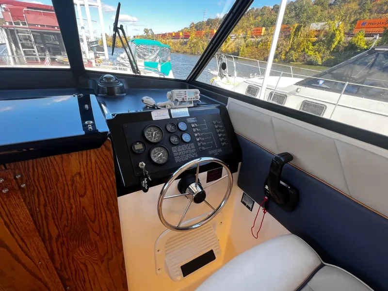 Slide: The Image of Interior helm of 1995 Bayliner 2859 Classic Cruiser with steering wheel and control panel. - 9
