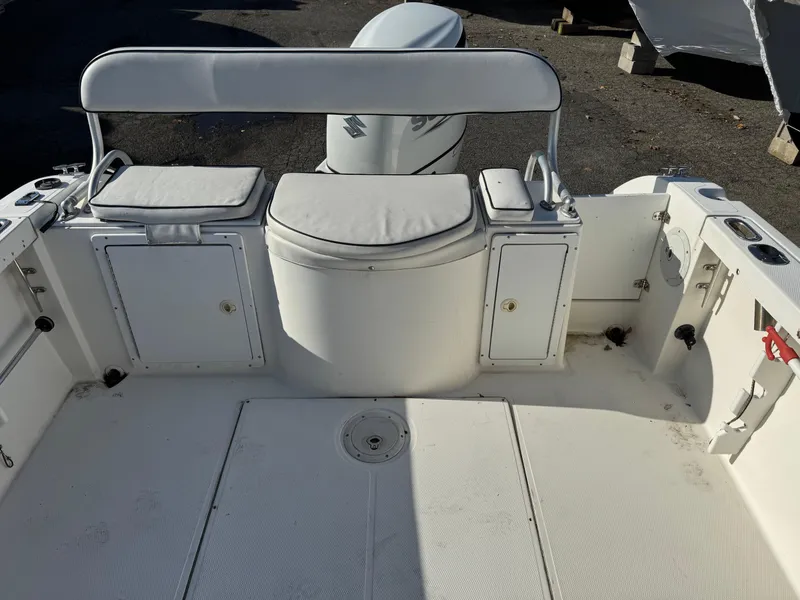 Slide: The Image of 1998 Cobia 220 Walkaround boat interior with cushioned seating and storage compartments. - 10