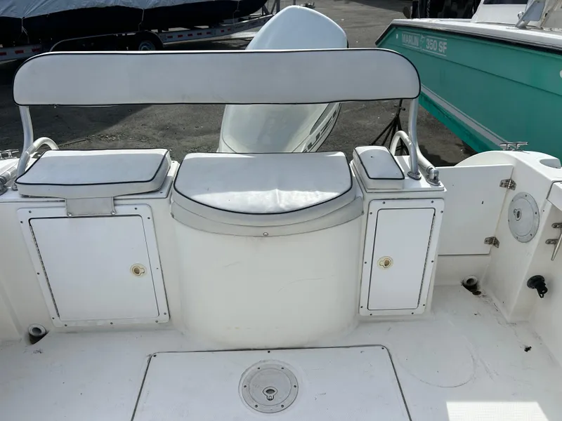 Slide: The Image of 1998 Cobia 220 Walkaround boat interior with seating and storage compartments. - 11