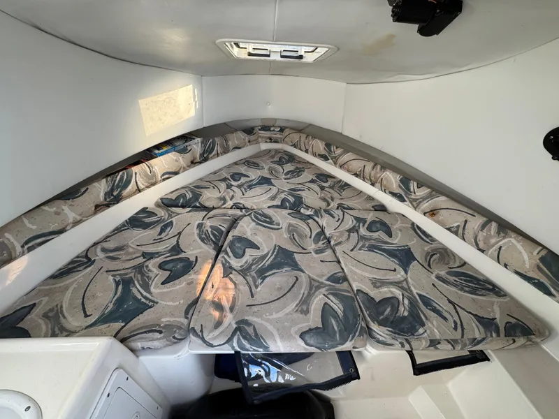 Slide: The Image of Interior cabin of 1998 Cobia 220 Walkaround with patterned cushions. - 13