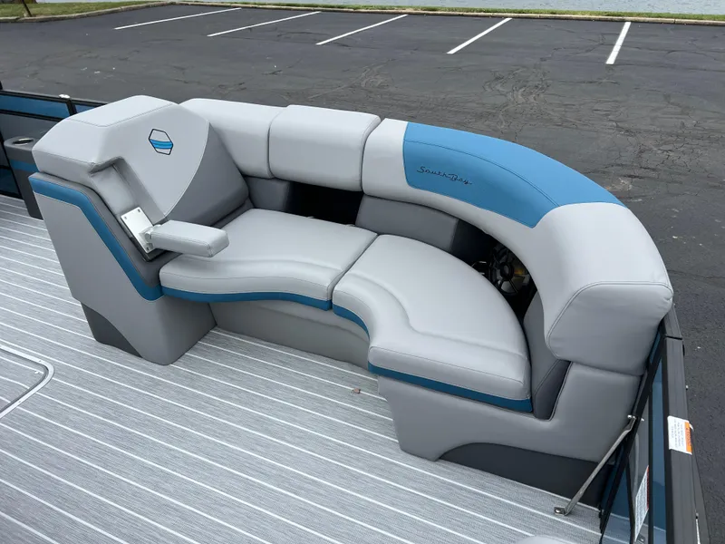 Slide: The Image of 2025 South Bay 523 RS3 3.0+ boat seating, gray and blue upholstery, in a parking lot. - 10