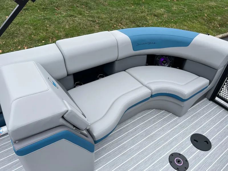Slide: The Image of 2025 South Bay 523 RS3 3.0+ boat interior with gray and blue seating. - 14