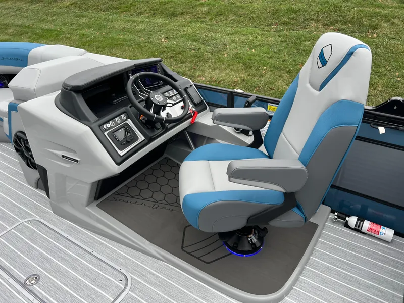 Slide: The Image of 2025 South Bay 523 RS3 3.0+ boat cockpit with modern steering and blue-gray seating. - 21