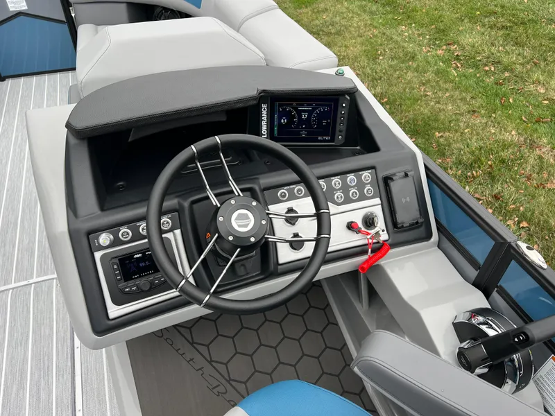 Slide: The Image of 2025 South Bay 523 RS3 3.0+ boat dashboard with steering wheel and control panel. - 23