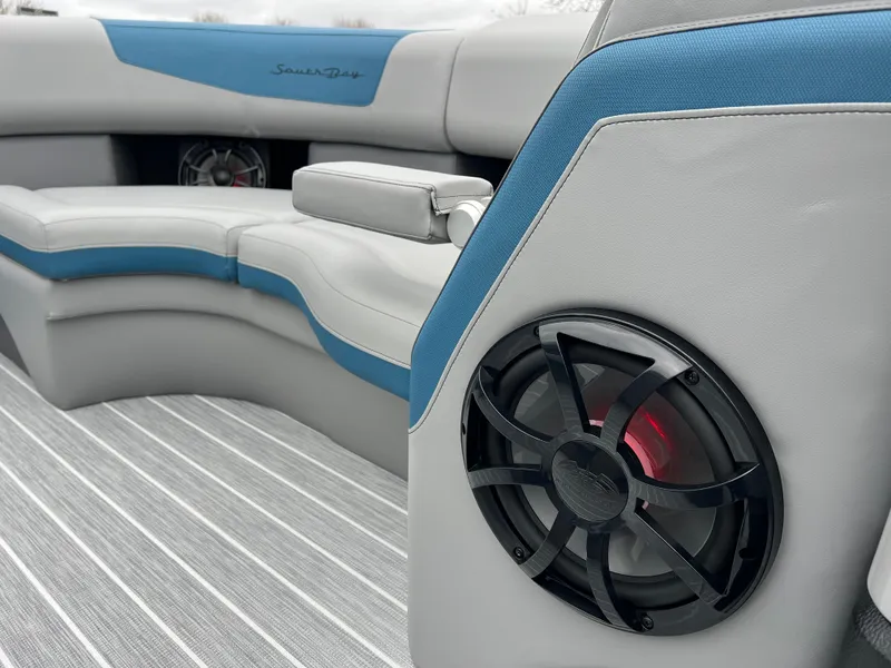 Slide: The Image of 2025 South Bay 523 RS3 3.0+ boat interior with speaker and cushioned seating. - 27