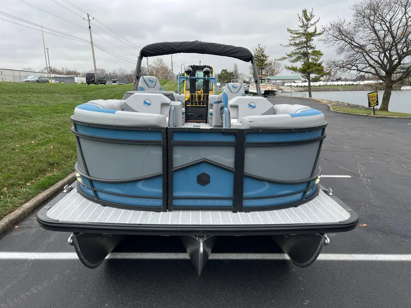 Slide: The Image of 2025 South Bay 523 RS3 3.0+ pontoon boat, blue and gray, parked on asphalt. - 3