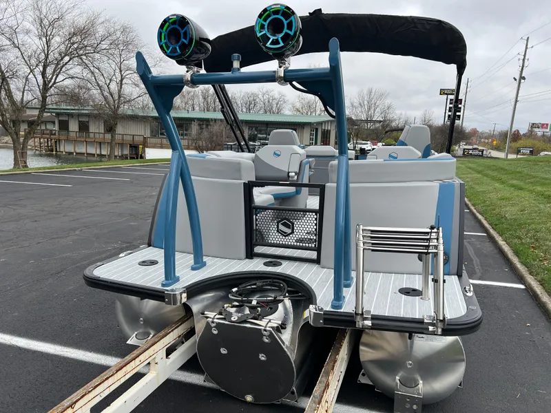 Slide: The Image of 2025 South Bay 523 RS3 3.0+ pontoon boat with speakers and seating, parked on a trailer. - 5