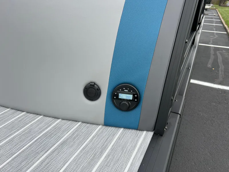 Slide: The Image of 2025 South Bay 523 RS3 3.0+ boat interior with control panel and striped upholstery. - 7