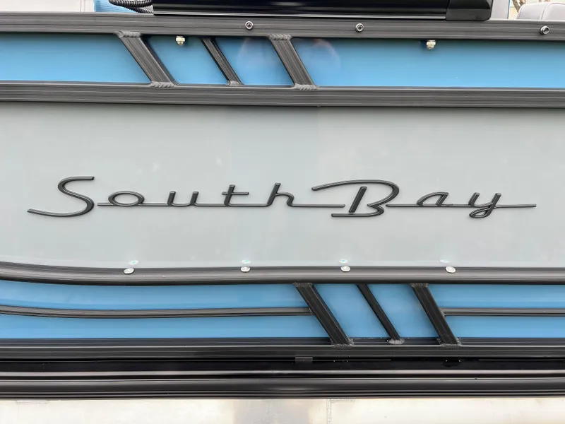 Slide: The Image of 2025 South Bay 523 RS3 3.0+ boat logo on sleek blue and gray panel. - 8