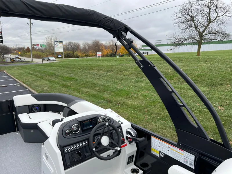 Slide: The Image of 2025 South Bay S224 RS 3.0 Hybrid Arch boat interior with steering console and seating. - 20
