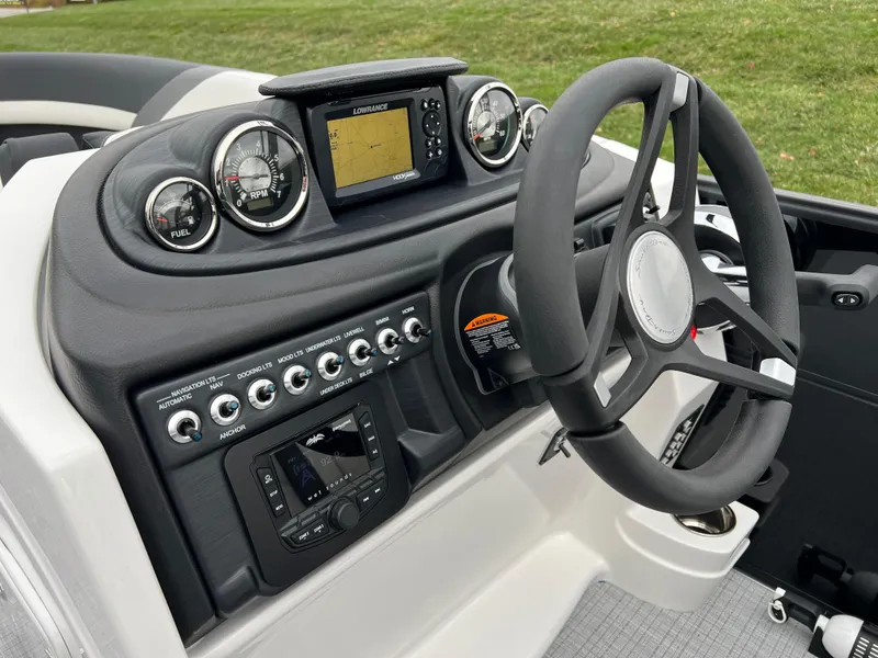 Slide: The Image of 2025 South Bay S224 RS 3.0 Hybrid Arch boat dashboard with steering wheel and controls. - 21