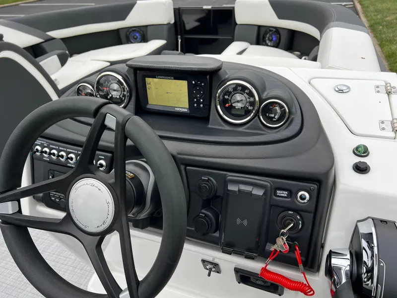 Slide: The Image of 2025 South Bay S224 RS 3.0 Hybrid Arch boat dashboard with steering wheel and controls. - 23