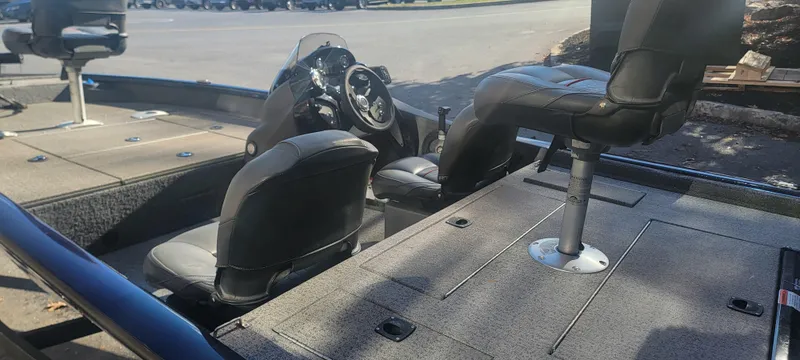 Slide: The Image of 2021 Tracker Pro Team 175 TF boat interior with seating and steering console. - 6