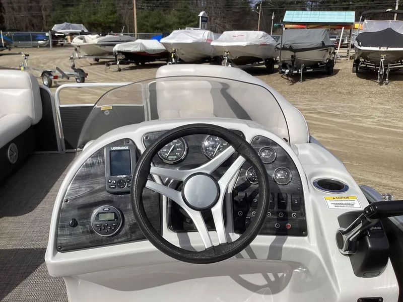 Slide: The Image of 2017 Godfrey SWEETWATER 2086 boat dashboard with steering wheel and control panel. - 7