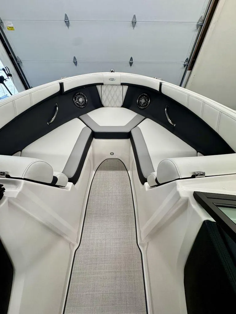 Slide: The Image of 2025 Regal 2000 ES boat interior with sleek white and black seating. - 12