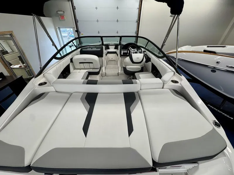 Slide: The Image of 2025 Regal 2000 ES boat interior with sleek seating and modern design in showroom. - 4