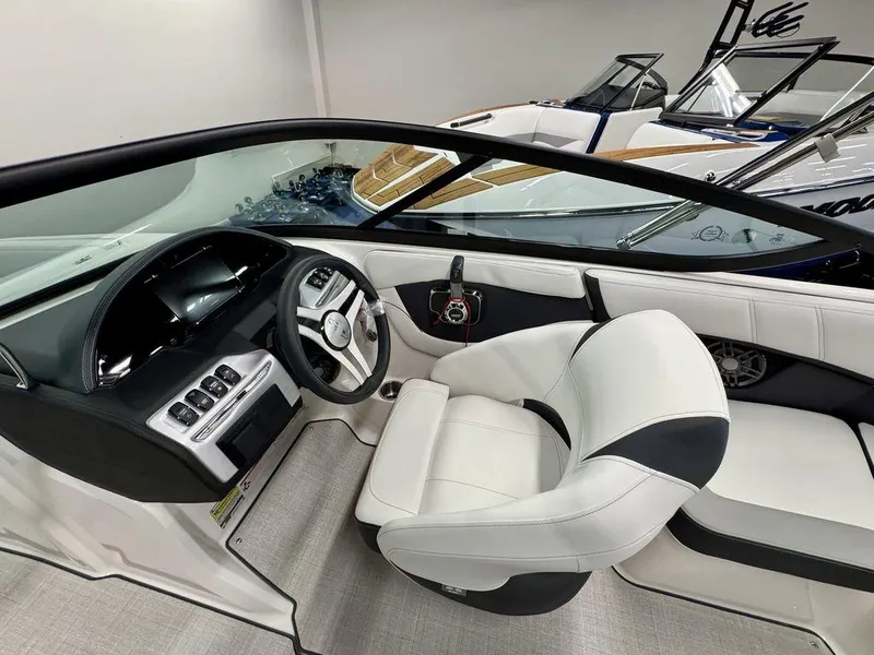 Slide: The Image of 2025 Regal 2000 ES boat interior with modern dashboard and white seating. - 8