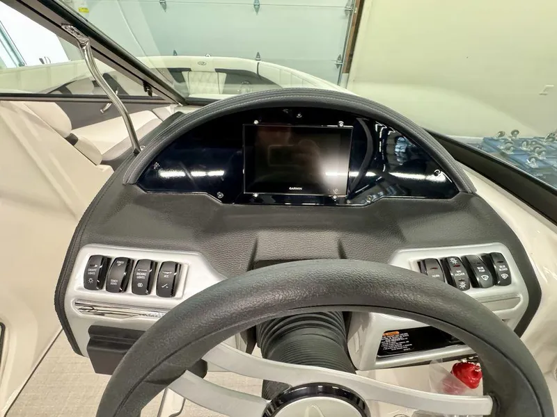 Slide: The Image of 2025 Regal 2000 ES boat dashboard with steering wheel and control panel. - 9